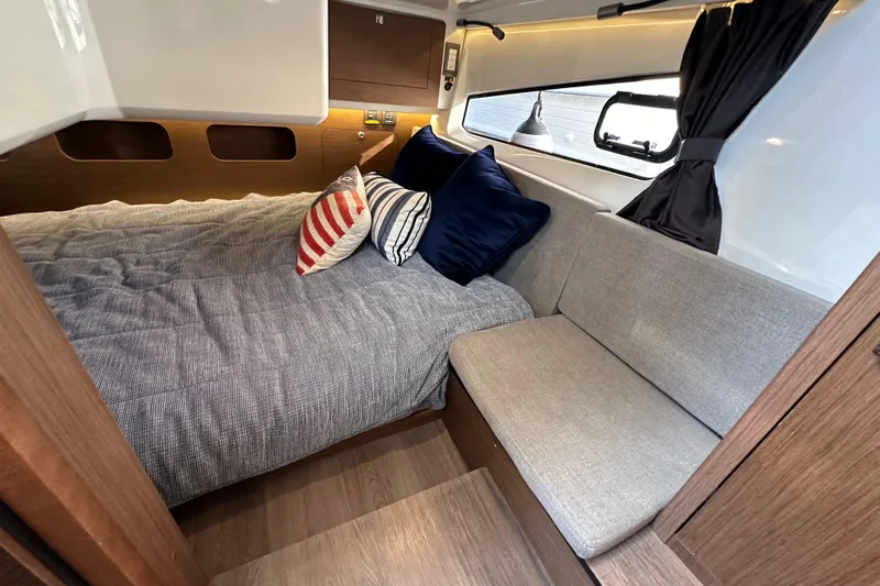 Vitamin Sea Yacht Photos Pics Luxurious cabin interior of 2023 Beneteau Antares 11 Fly with cozy bedding and seating.