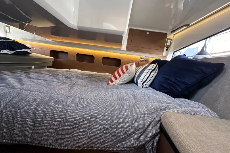 Vitamin Sea Yacht Photos Pics Luxurious cabin interior of 2023 Beneteau Antares 11 Fly with cozy bedding and pillows.