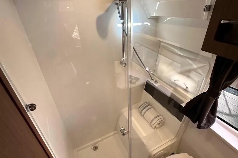 Vitamin Sea Yacht Photos Pics Modern bathroom interior of 2023 Beneteau Antares 11 Fly yacht, featuring sleek shower design.