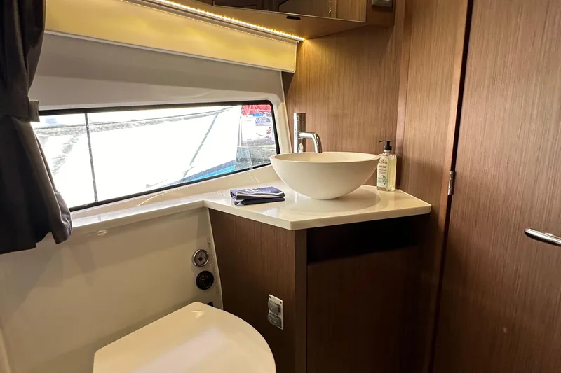 Vitamin Sea Yacht Photos Pics Modern bathroom interior of 2023 Beneteau Antares 11 Fly yacht, featuring sleek sink design.