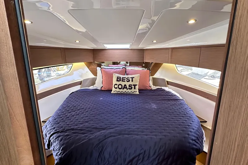 Vitamin Sea Yacht Photos Pics Luxurious cabin interior of 2023 Beneteau Antares 11 Fly with cozy bedding and stylish decor.