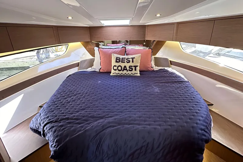 Vitamin Sea Yacht Photos Pics Luxurious cabin interior of 2023 Beneteau Antares 11 Fly with cozy bedding and stylish decor.