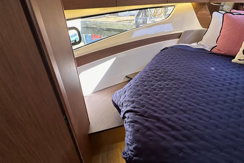 Vitamin Sea Yacht Photos Pics Luxurious cabin interior of 2023 Beneteau Antares 11 Fly with cozy bedding and modern design.
