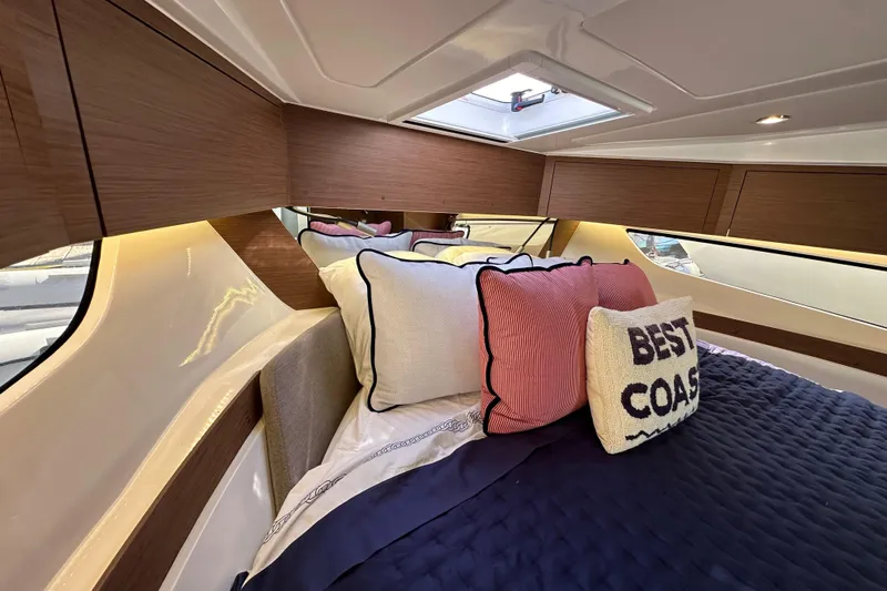 Vitamin Sea Yacht Photos Pics Luxurious cabin interior of 2023 Beneteau Antares 11 Fly with stylish bedding and cushions.