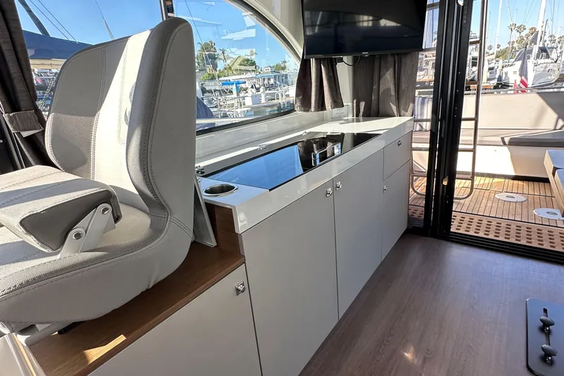 Vitamin Sea Yacht Photos Pics Interior of 2023 Beneteau Antares 11 Fly, featuring modern helm and sleek cabinetry.