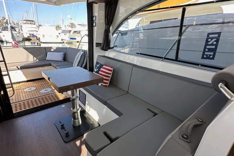 Vitamin Sea Yacht Photos Pics Interior of 2023 Beneteau Antares 11 Fly yacht with modern seating and table.