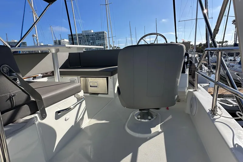 Vitamin Sea Yacht Photos Pics Flybridge of 2023 Beneteau Antares 11 Fly with seating and helm, docked in marina.