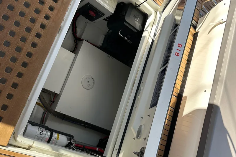 Vitamin Sea Yacht Photos Pics 2023 Beneteau Antares 11 Fly engine compartment with safety equipment and storage.