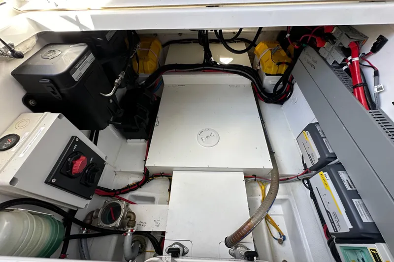 Vitamin Sea Yacht Photos Pics Engine compartment of 2023 Beneteau Antares 11 Fly, showcasing wiring and battery systems.