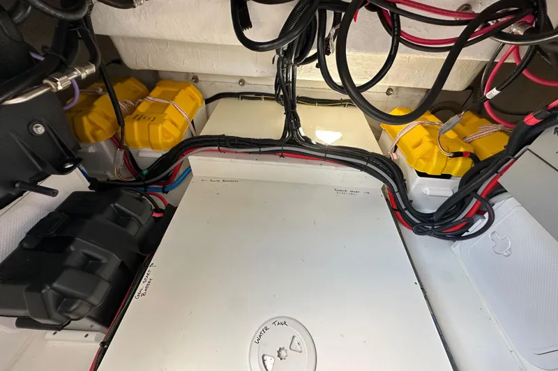 Vitamin Sea Yacht Photos Pics Engine compartment of 2023 Beneteau Antares 11 Fly with batteries and wiring.