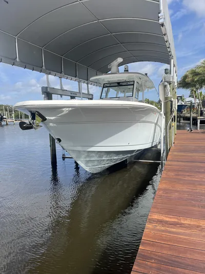  Yacht Photos Pics 2021 Sea Fox 368 Commander boat docked under a canopy on calm water.