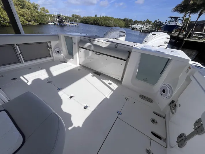  Yacht Photos Pics 2021 Sea Fox 368 Commander boat deck with Yamaha engines, docked by a scenic waterfront.