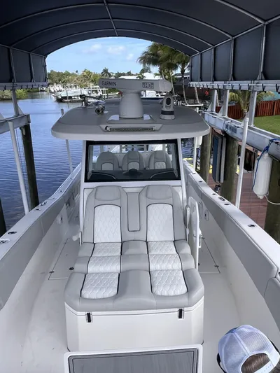  Yacht Photos Pics 2021 Sea Fox 368 Commander boat with cushioned seating, docked under a canopy.