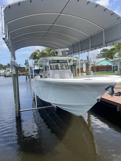  Yacht Photos Pics 2021 Sea Fox 368 Commander boat docked under a canopy in a marina.