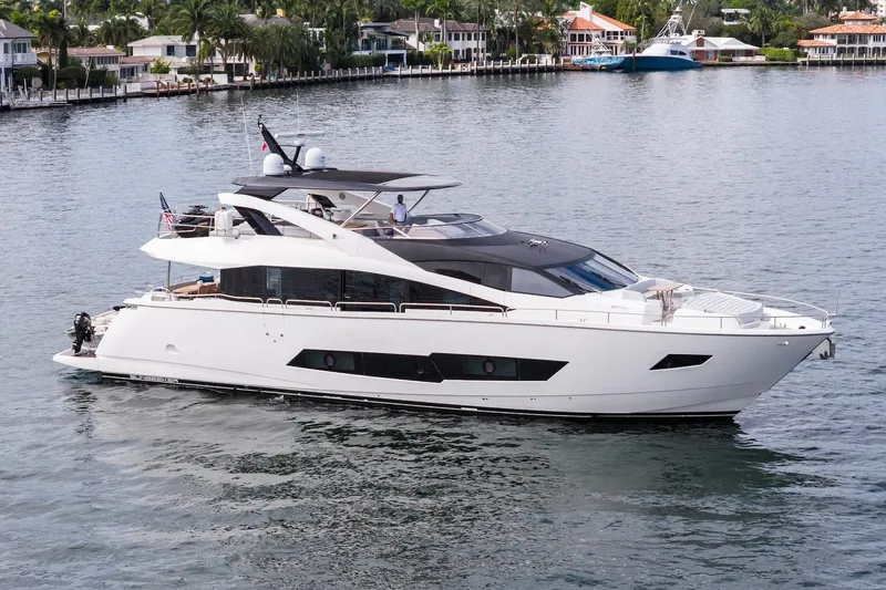 Aqua Vista Yacht Photos Pics Luxurious 2019 Sunseeker 86 Yacht cruising on serene waters near waterfront homes.