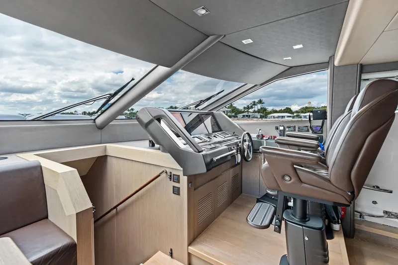 Aqua Vista Yacht Photos Pics Luxurious helm of 2019 Sunseeker 86 Yacht with modern controls and leather seating.