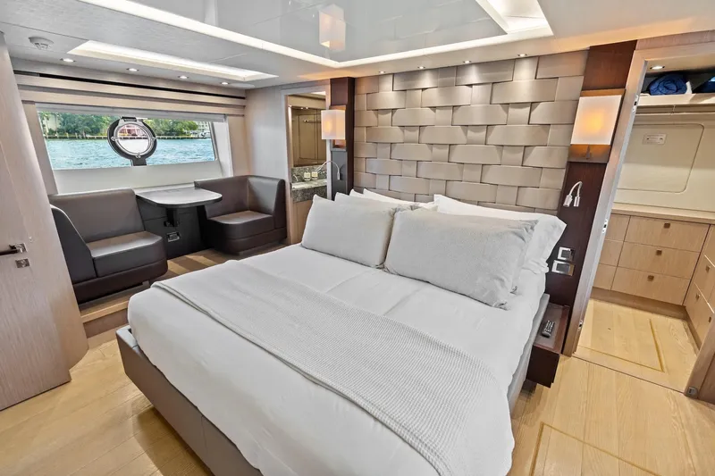Aqua Vista Yacht Photos Pics Luxurious bedroom interior of 2019 Sunseeker 86 Yacht with modern design and scenic window view.