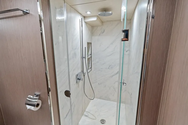 Aqua Vista Yacht Photos Pics Luxurious shower in 2019 Sunseeker 86 Yacht with marble walls and modern fixtures.
