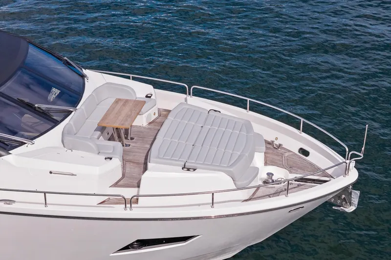 Aqua Vista Yacht Photos Pics Luxurious 2019 Sunseeker 86 Yacht with elegant deck seating and table on calm waters.