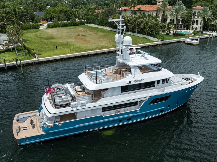 Uptight Yacht Photos Pics Luxury yacht Cantiere Delle Marche Darwin 106, 2022 model, cruising near lush waterfront estate.