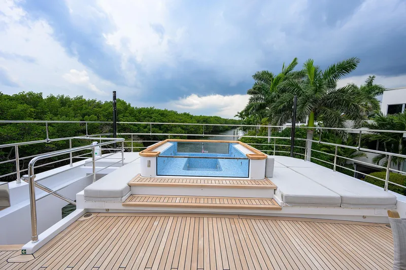 Uptight Yacht Photos Pics Luxury yacht deck with pool, Cantiere Delle Marche Darwin 106, 2022 model, surrounded by lush greenery.