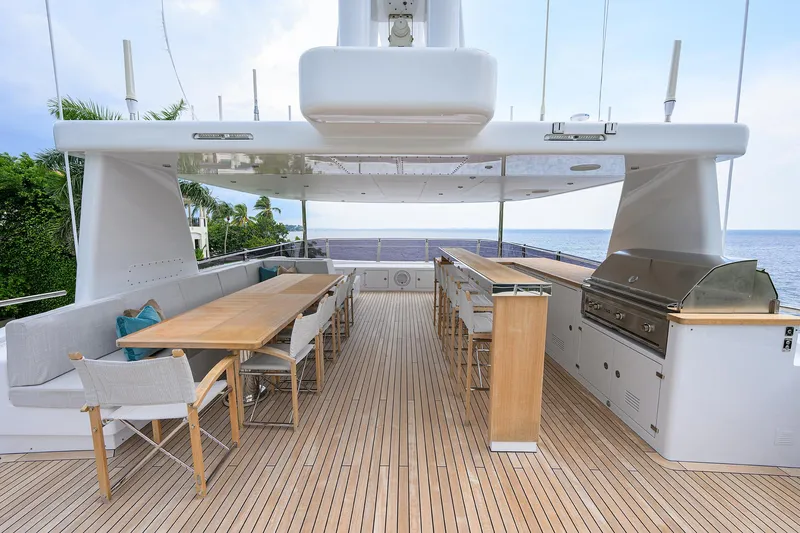 Uptight Yacht Photos Pics Luxurious 2022 Cantiere Delle Marche Darwin 106 yacht deck with dining area and grill.
