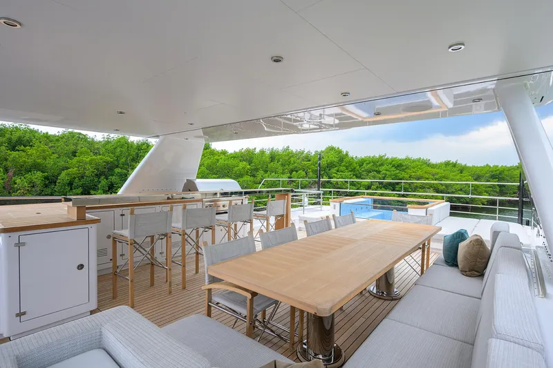 Uptight Yacht Photos Pics Luxurious 2022 Cantiere Delle Marche Darwin 106 yacht deck with dining area and scenic view.