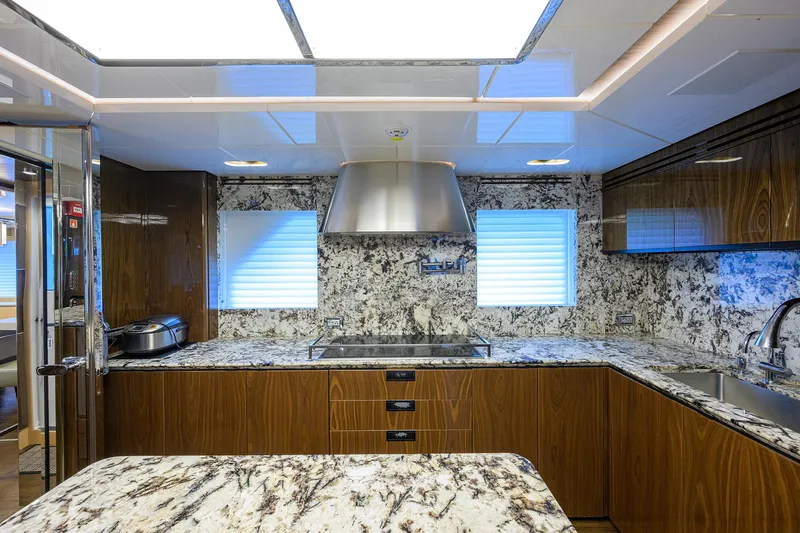 Uptight Yacht Photos Pics Luxurious kitchen interior of 2022 Cantiere Delle Marche Darwin 106 yacht with marble countertops.