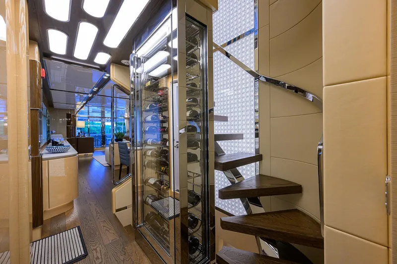 Uptight Yacht Photos Pics Luxurious interior of 2022 Cantiere Delle Marche Darwin 106 yacht with modern staircase and wine storage.