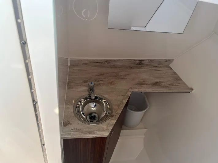  Yacht Photos Pics 2018 Pursuit DC 295 Dual Console boat interior with sink and countertop.