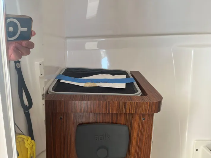  Yacht Photos Pics 2018 Pursuit DC 295 Dual Console interior with wooden cabinet and speaker.