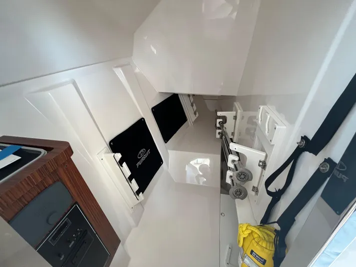  Yacht Photos Pics Interior of 2018 Pursuit DC 295 Dual Console boat, featuring storage and safety equipment.