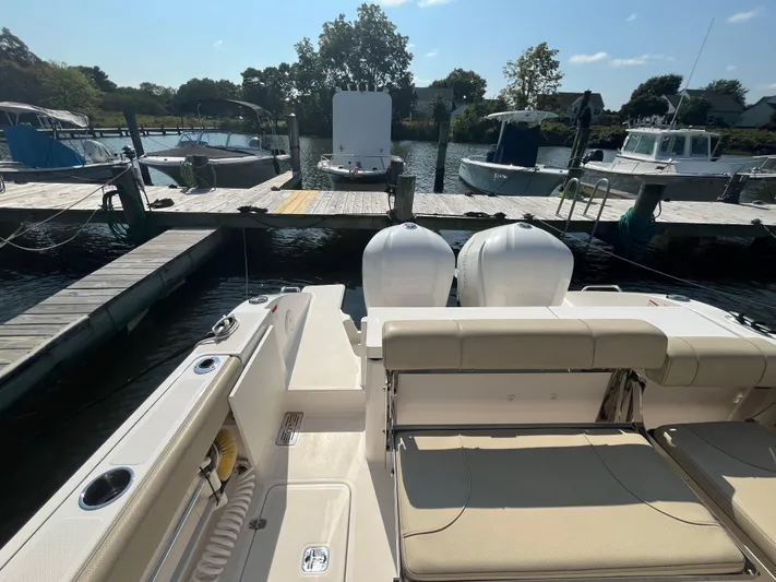  Yacht Photos Pics 2018 Pursuit DC 295 Dual Console boat docked at marina with twin engines.