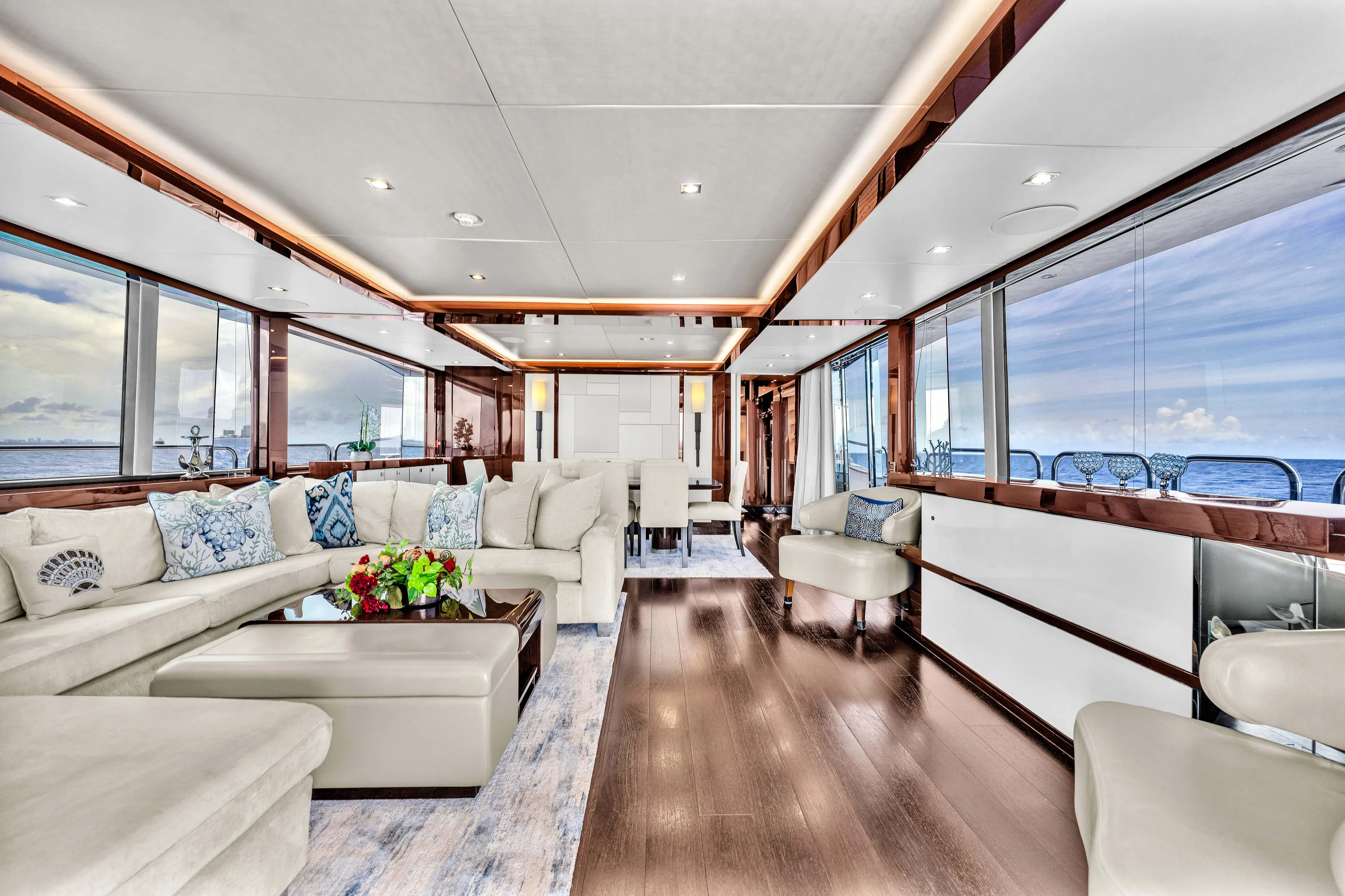 Karillian & Company Yacht Photos Pics Luxurious interior of 2018 Sunseeker 95 Yacht with elegant seating and ocean views.