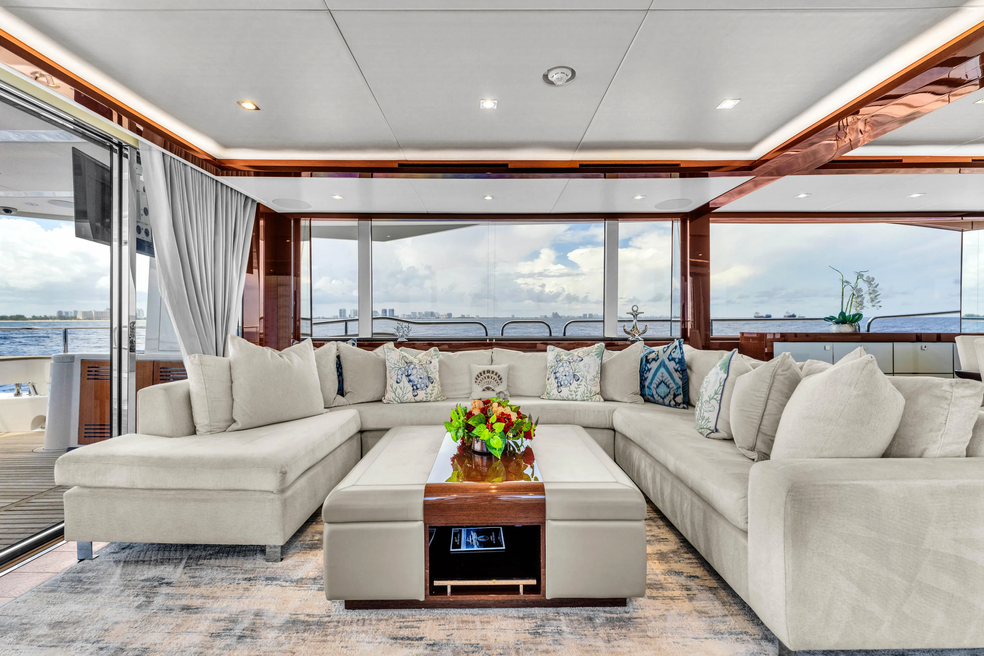 Karillian & Company Yacht Photos Pics Luxurious interior of 2018 Sunseeker 95 Yacht with elegant seating and panoramic windows.