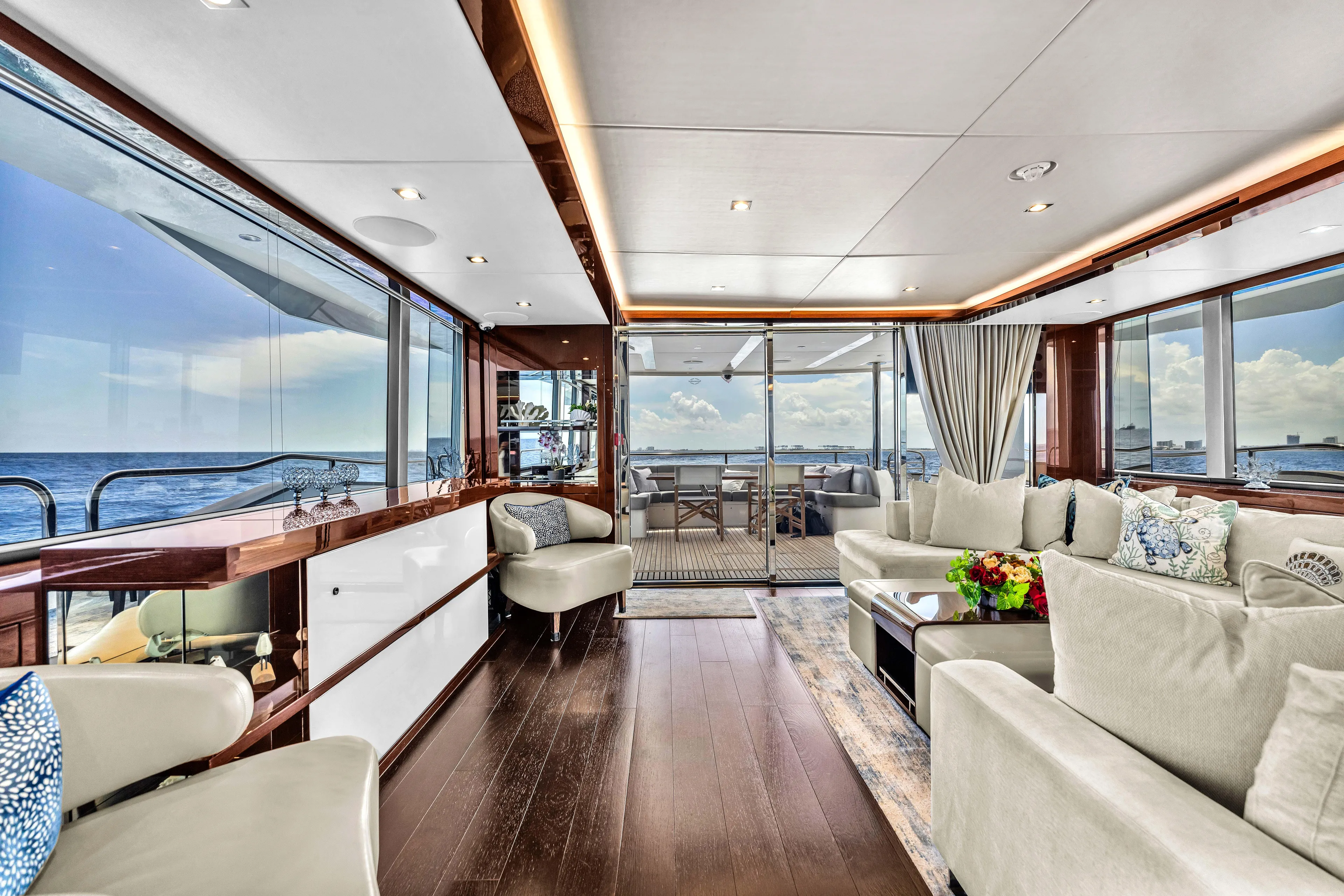 Karillian & Company Yacht Photos Pics Luxurious interior of 2018 Sunseeker 95 Yacht with ocean view and elegant furnishings.