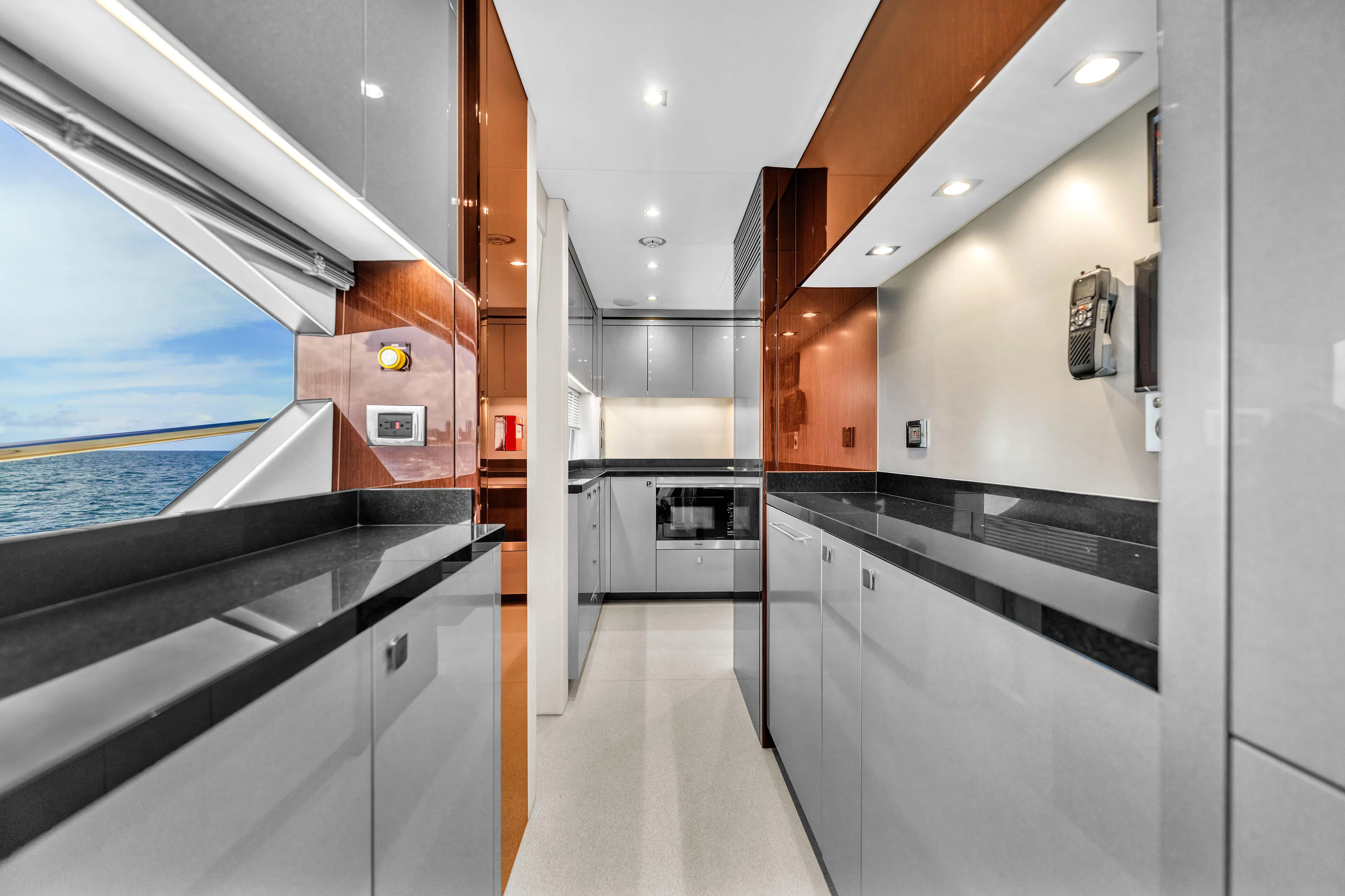 Karillian & Company Yacht Photos Pics Luxurious kitchen interior of 2018 Sunseeker 95 Yacht with sleek cabinetry and ocean view.
