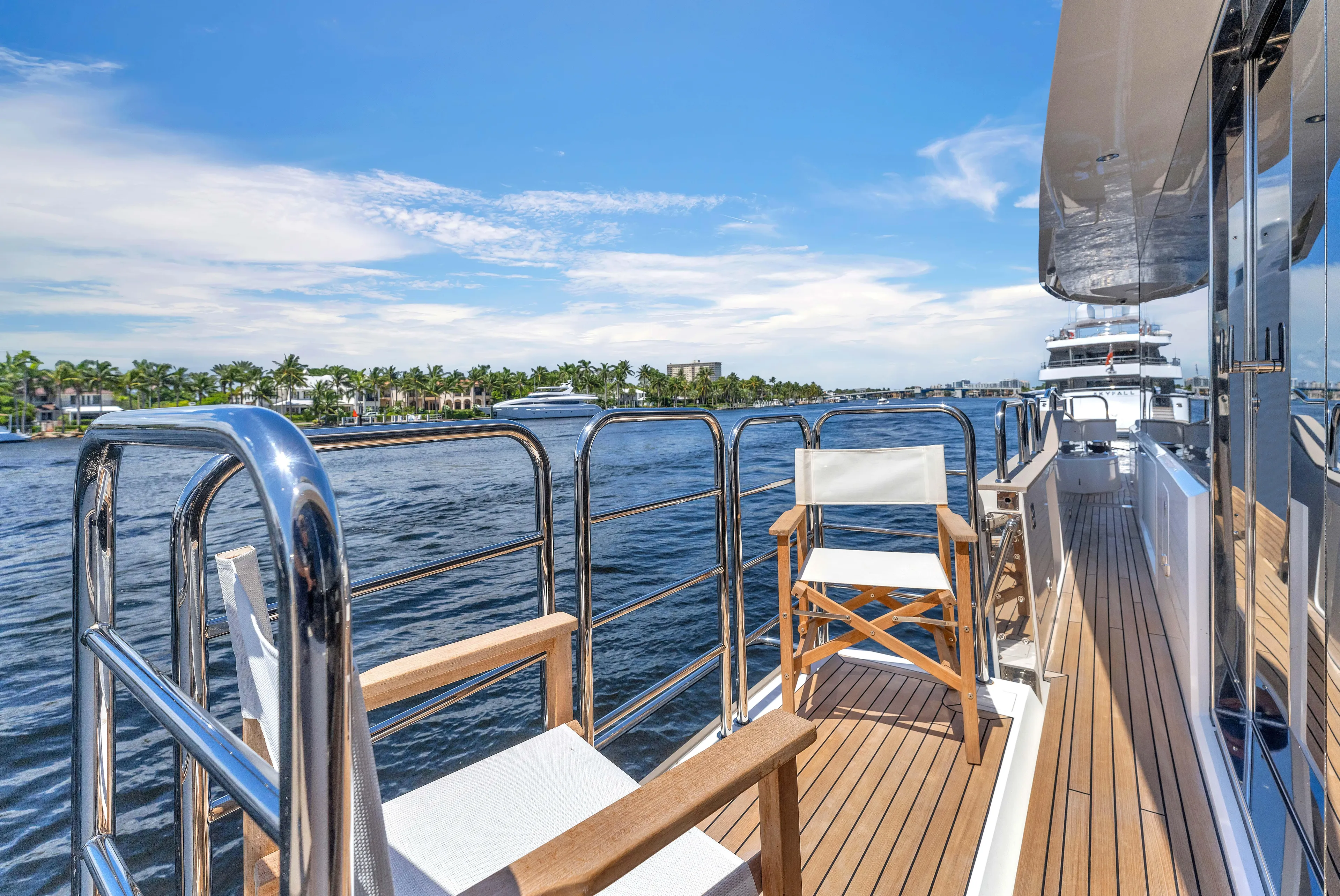 Karillian & Company Yacht Photos Pics Sunseeker 95 Yacht 2018 deck with chairs, overlooking serene water and blue sky.