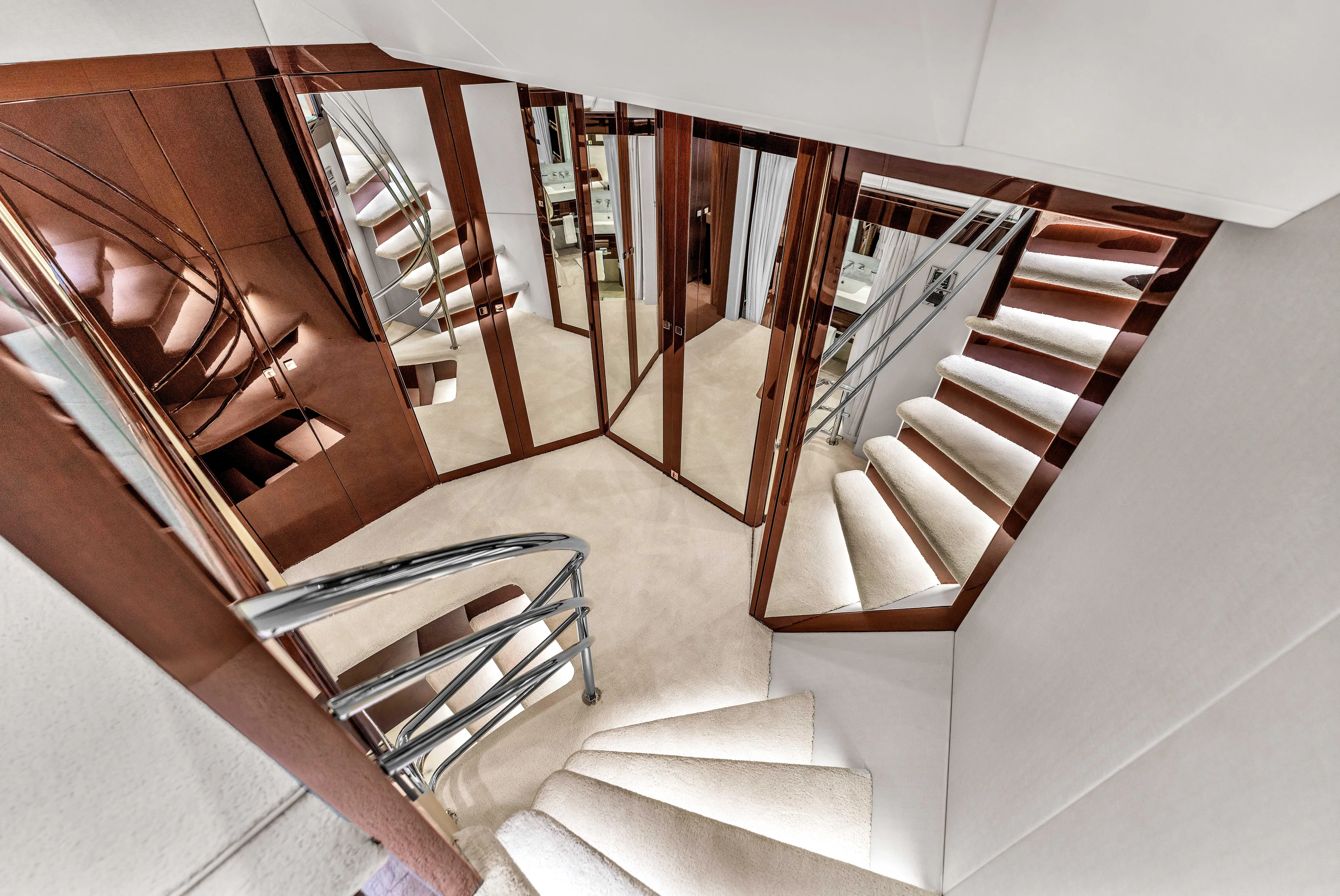 Karillian & Company Yacht Photos Pics Luxurious interior staircase of 2018 Sunseeker 95 Yacht with mirrored walls.