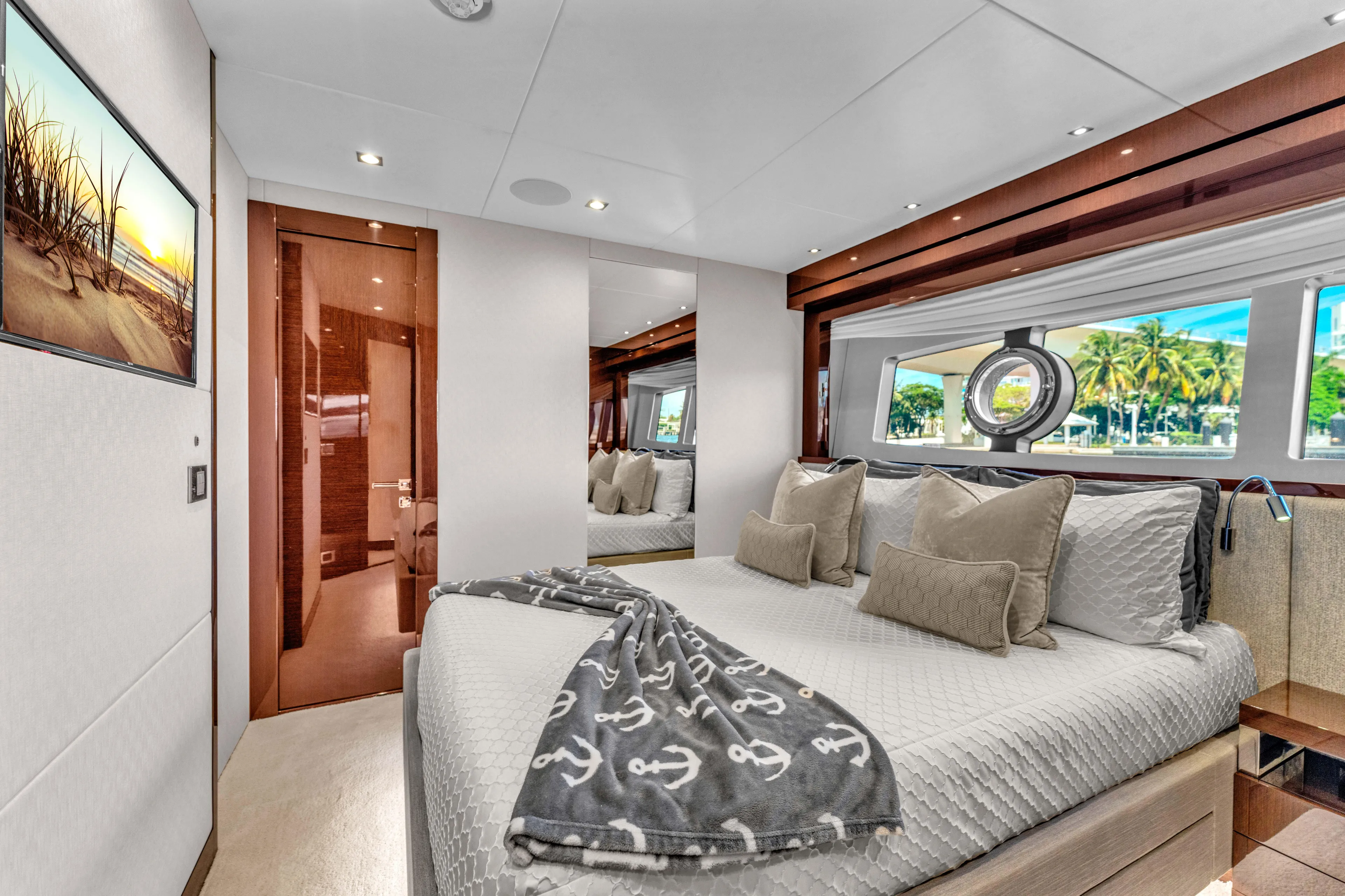 Karillian & Company Yacht Photos Pics Luxurious bedroom interior of 2018 Sunseeker 95 Yacht with elegant decor and scenic window view.