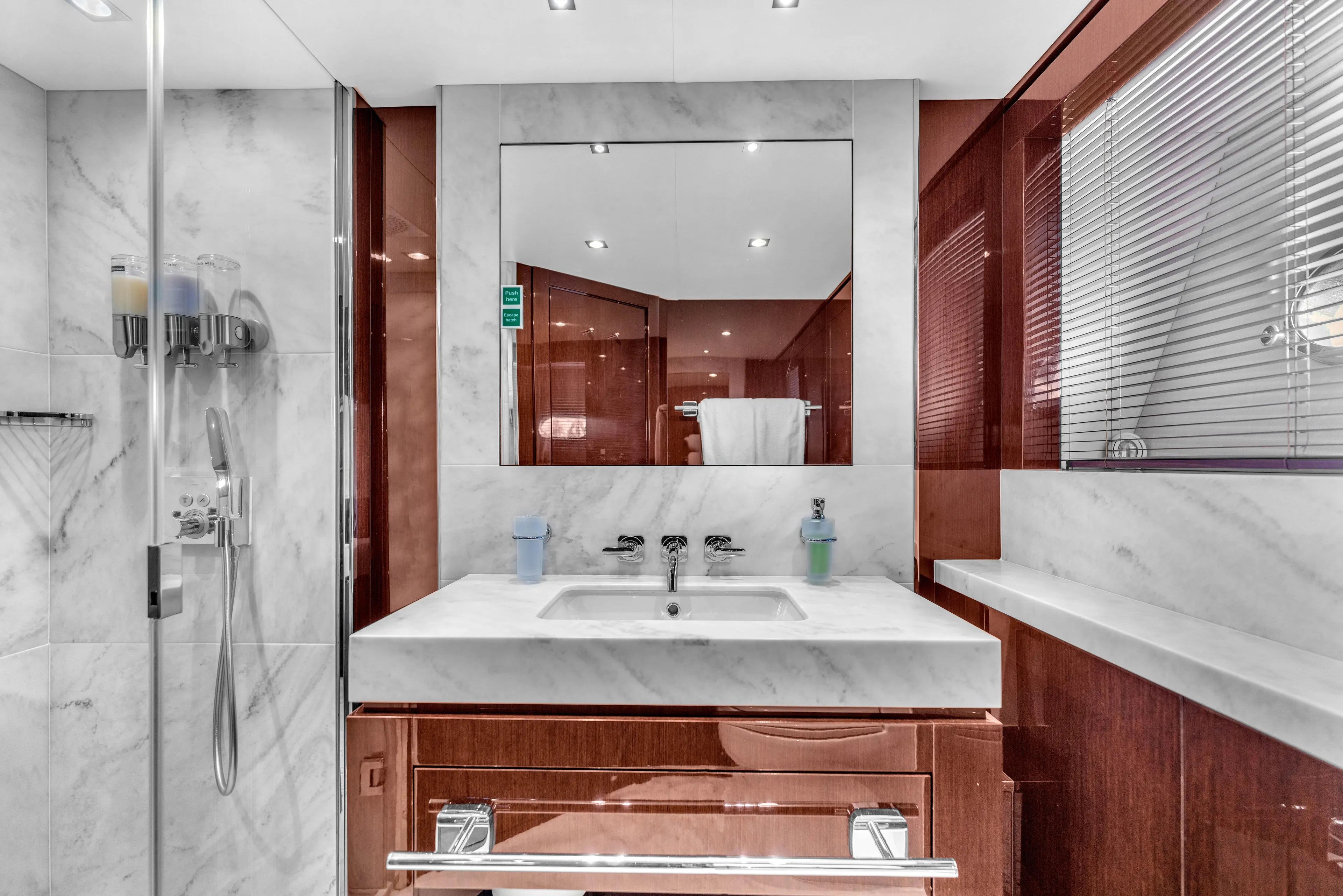 Karillian & Company Yacht Photos Pics Luxurious bathroom in 2018 Sunseeker 95 Yacht with marble and wood finishes.