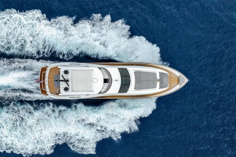 Karillian & Company Yacht Photos Pics Aerial view of 2018 Sunseeker 95 Yacht cruising on blue ocean waters.