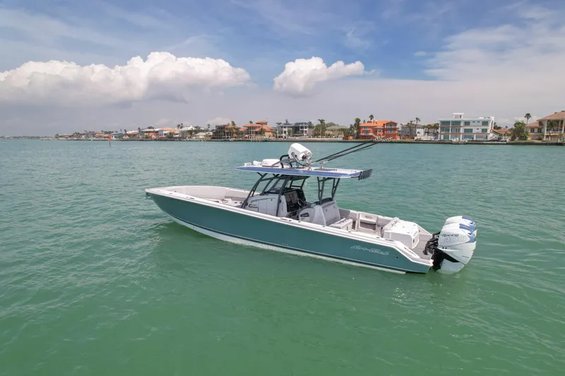 My Mermaid Yacht Photos Pics 2020 Nor-Tech 390 Sport Center Console boat on calm water, coastal homes in background.