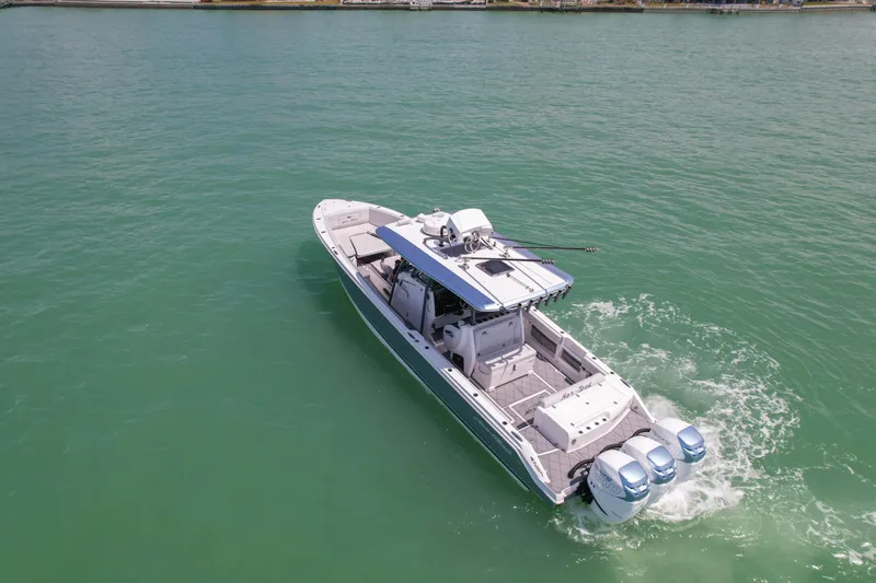 My Mermaid Yacht Photos Pics 2020 Nor-Tech 390 Sport Center Console boat cruising on clear turquoise water.