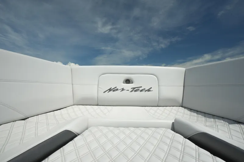 My Mermaid Yacht Photos Pics 2020 Nor-Tech 390 Sport Center Console boat interior with white quilted seating under blue sky.