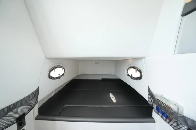 My Mermaid Yacht Photos Pics 2020 Nor-Tech 390 Sport Center Console cabin interior with sleek black seating and portholes.