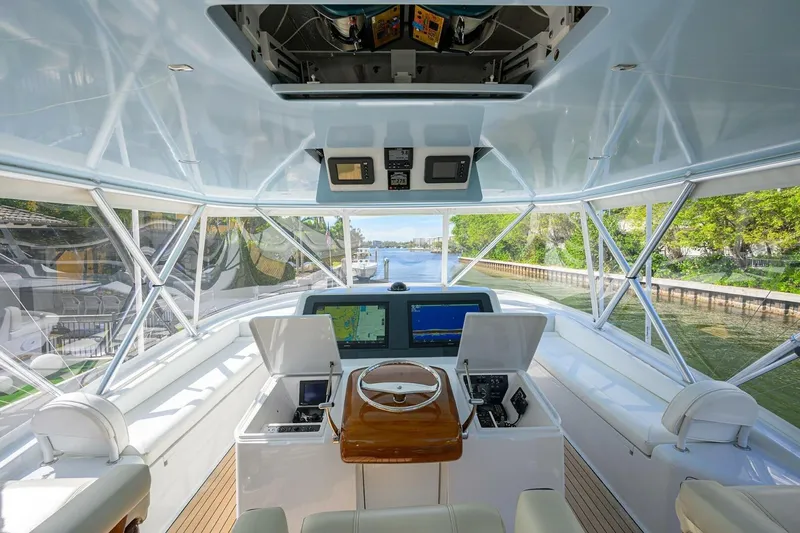 Pryorities Yacht Photos Pics 2008 Viking 60 Convertible yacht helm with navigation screens and panoramic waterway view.