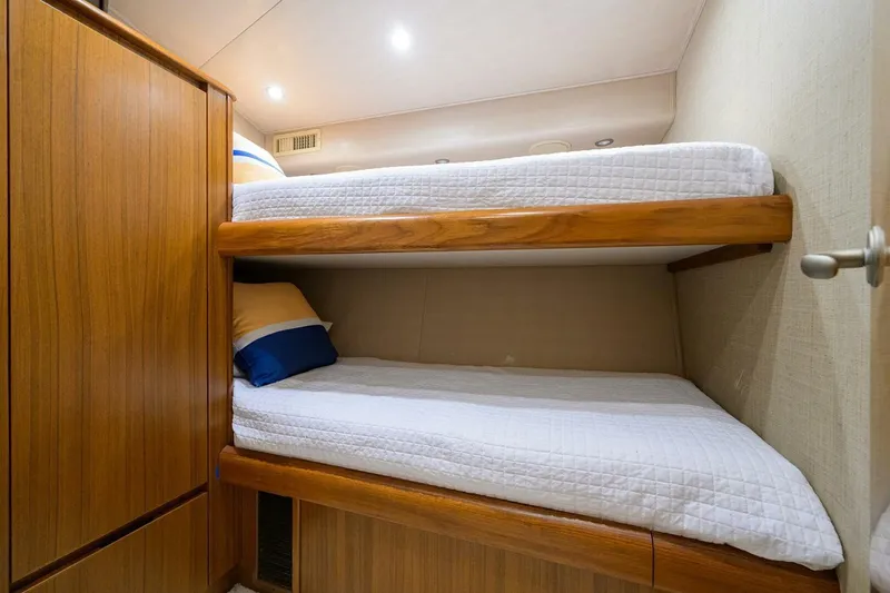 Pryorities Yacht Photos Pics Bunk beds in 2008 Viking 60 Convertible yacht cabin with wooden finishes.