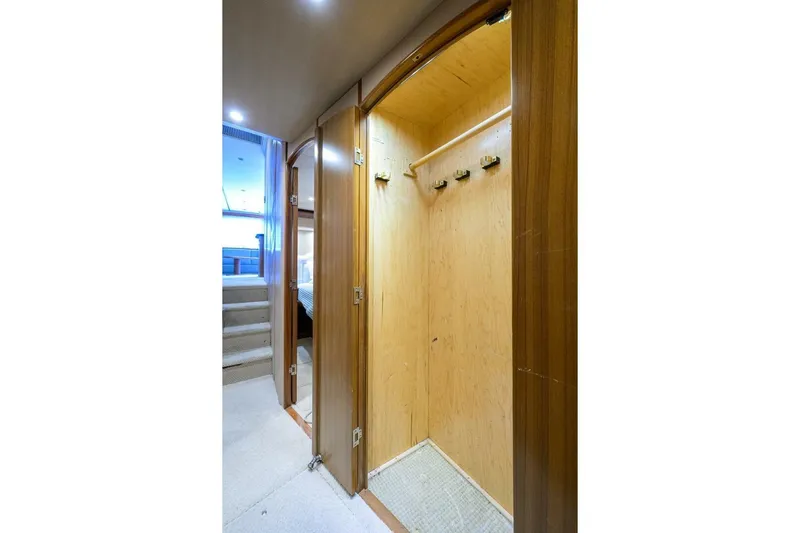 Pryorities Yacht Photos Pics Interior view of 2008 Viking 60 Convertible yacht showing wooden closet and carpeted stairs.
