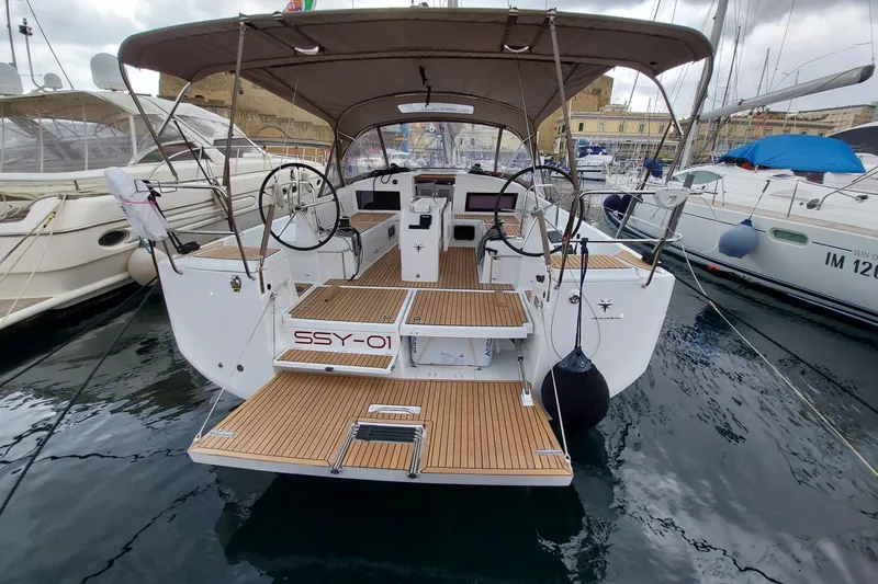 Ssy 01 Yacht Photos Pics 2021 Jeanneau Sun Odyssey 440 yacht docked, featuring dual steering wheels and teak decking.
